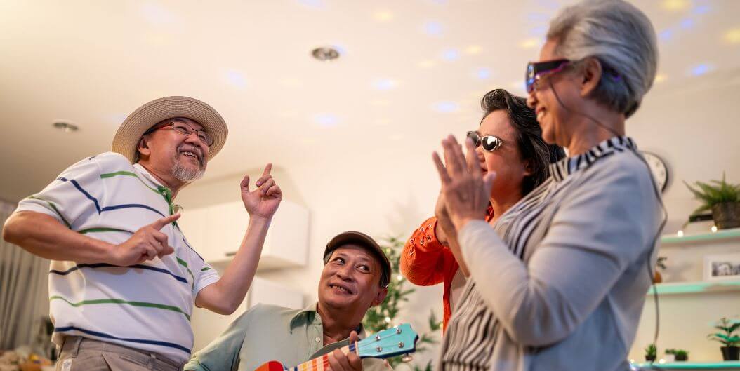 A Group of Seniors Listening to Guitar in Mobile Independent Living Facility