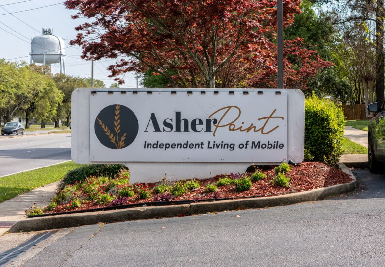 Welcoming Entrance Sign Surrounded by Landscaped Garden at Independent Living Facility Welcoming Entrance Sign Surrounded by Landscaped Garden at Independent Living Facility