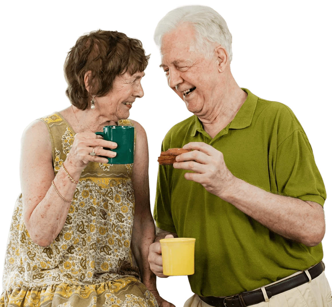 Elderly Couple Laughing Over Coffee and a Pastry in Independent Living Elderly Couple Laughing Over Coffee and a Pastry in Independent Living