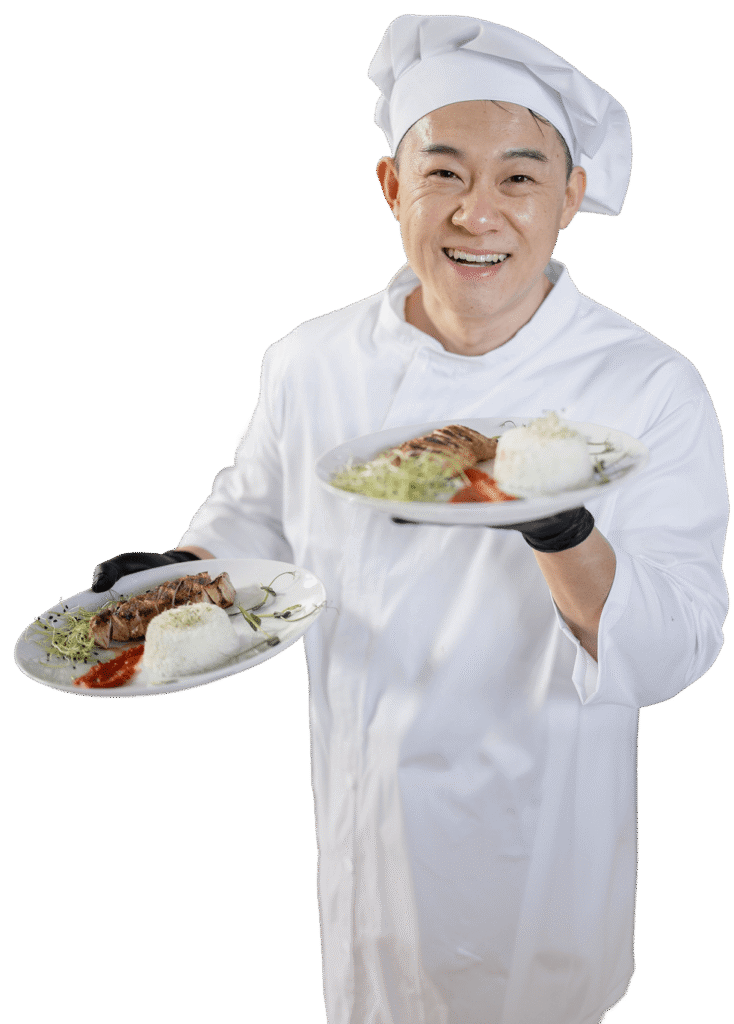 Smiling Chef Presenting Two Plated Entrees at an Independent Living Facility Smiling Chef Presenting Two Plated Entrees at an Independent Living Facility